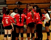 McNair volleyball coach Gwen Edwards (in middle) goes over some strategy with the Lady Mustangs during a timeout. (Photo by Mark Brock)