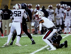 Cedar Grove linebacker Keith Bass (24) brings down the Sandy Creek quarterback for a sack in the Saints' regular season win. Bass and his teammates take on Bremen on Friday night in the Sweet 16 round of the Class 3A state playoffs. (Photo by Mark Brock)
