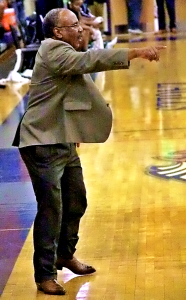 Columbia boys' basketball coach Dr. Phillip McCrary guides his team's offense in a game last season. (Photo by Mark Brock)