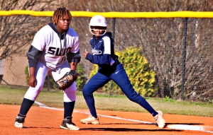 Redan's Destinee Johnson (right) takes off from first on the pitch while Southwest DeKalb first baseman Jayla Jones (left) gets set to play defense. (Photo by Mark Brock)