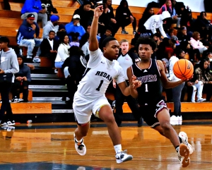 Redan's William Bankhead (left) defends against Towers' Domyius McFarland (right) during Redan's 65-61 comeback against the Titans. Bankhead hit the game-winning three-pointer at the buzzer to cap the comeback. (Photo by Mark Brock)