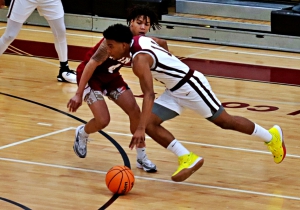 Tucker' Khayri Dunn (11) drives against Martin Luther King's Devin Bowers (4) during first half high school basketball action at Tucker. Dunn would later score the winning basket with 3.5 seconds to play in a 57-56 Tucker win. (Photo by Mark Brock)