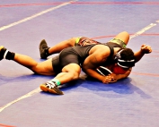 Southwest DeKalb's Isaiah Scott shown getting a pin in the county championships is trying to repeat as a state champion at the GHSA Class 5A State Wrestling Championships this weekend. (Photo by Mark Brock)