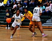 Arabia Mountain's Sha'nya Heath (5) drives past Eagle's Landing's Mahogany Brown (2) with the help of a pick by teammate Angelina Billingsley (21). Heath hit for 33 points in the game to lead the Rams to a 58-46 win. (Photo by Mark Brock)