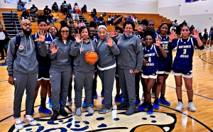 Southwest DeKalb girls' basketball head coach Kathy Richey-Walton (with ball) celebrates her 500th career victory with her 2024 staff and team following the win over Stephenson this week. (Courtesy Photo)