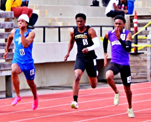 Two of the key players in the tie for the boys' title were Stephenson's Ca'Von Lucas (left) and Tucker's Christian Whitmore (middle) as they came in behind meet MVP Ali Dargan of Miller Grove in the 100-meter dash. (Photo by Mark Brock)