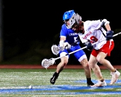 Chamblee's Luke Phillips (5) battles Druid Hills' Adam Green (10) on the face off following a goal. Phillips ended up advancing the loose ball up the field. (Photo by Mark Brock)