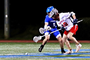 Chamblee's Luke Phillips (5) battles Druid Hills' Adam Green (10) on the face off following a goal. Phillips ended up advancing the loose ball up the field. (Photo by Mark Brock)