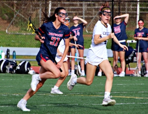 Dunwoody's Eydie Berrong (31) moves up field against Lakeside's Regan Taylor (4). Berrong finished with three goals in a tough area loss to Lakeside. (Photo by Mark Brock)