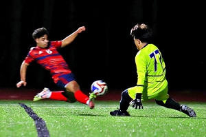South Cobb keeper Yeshua Carbajal (77) won this battle with Dunwoody's Jordi Orellana (8), but just minutes later Orellana put a header into the goal on a Will Lamb corner kick. (Photo by Mark Brock)