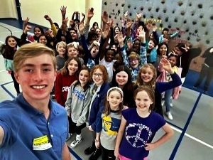 Lakeside senior lacrosse and swim athlete Indiana Crawford with Sagamore Hills Elementary students. Crawford provided insight for a more positive life during his talk with the students. 