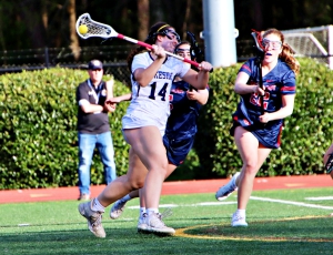 Lakeside's Reagan Flanagan (14) takes a shot as Dunwoody's Caroline Samuelson defends during Lakeside's 14-9 area win. Flanagan finished the night with eight goals and three assists. (Photo by Mark Brock)