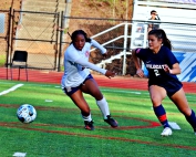 Dunwoody's Ella Ryan (right) gets past South Cobb defender Trinity McDaniel during an 8-0 first half by the Lady Wildcats. Ryan scored on goal and assisted on two more in the 9-0 victory. (Photo by Mark Brock)