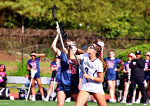 Lakeside's Marie Rollman (7) battles Dunwoody's Cara Eldridge (15) on a faceoff during regluar season play. Rollman and her Lady Viking teammates are making a second  consecutive state playoff appearance. (Photo by Mark Brock)