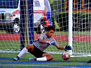 Henderson Cougar keeper Ryan Guzman goes down for a save against Peachtree. (Photo by Mark Brock)